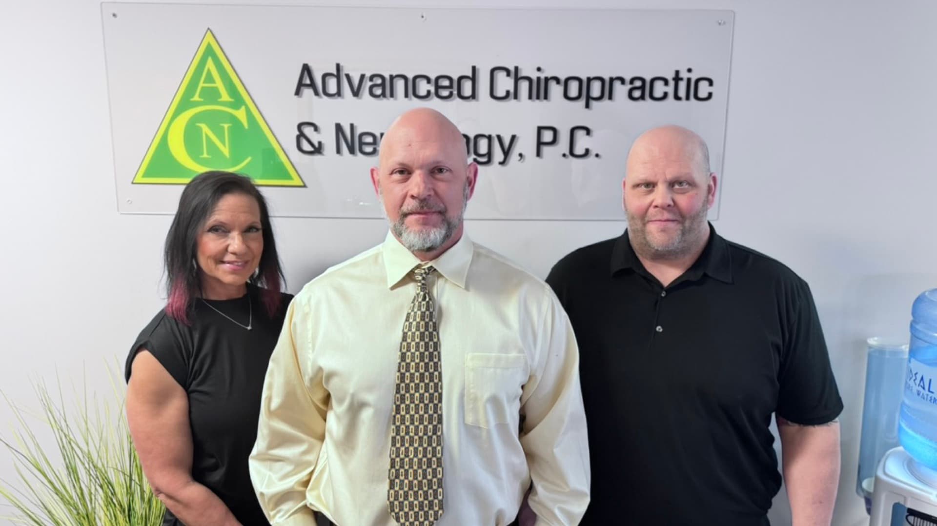 Advanced Chiropractic and Neurology team standing by the office sign in La Vista, NE